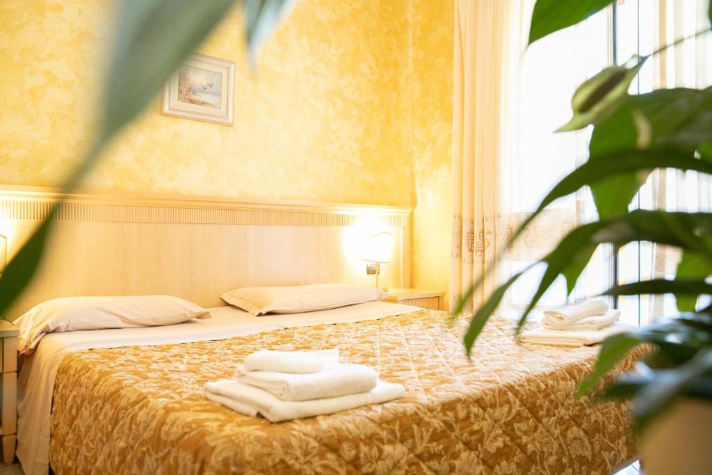Postel nebo postele na pokoji v ubytování Mannu Hotel