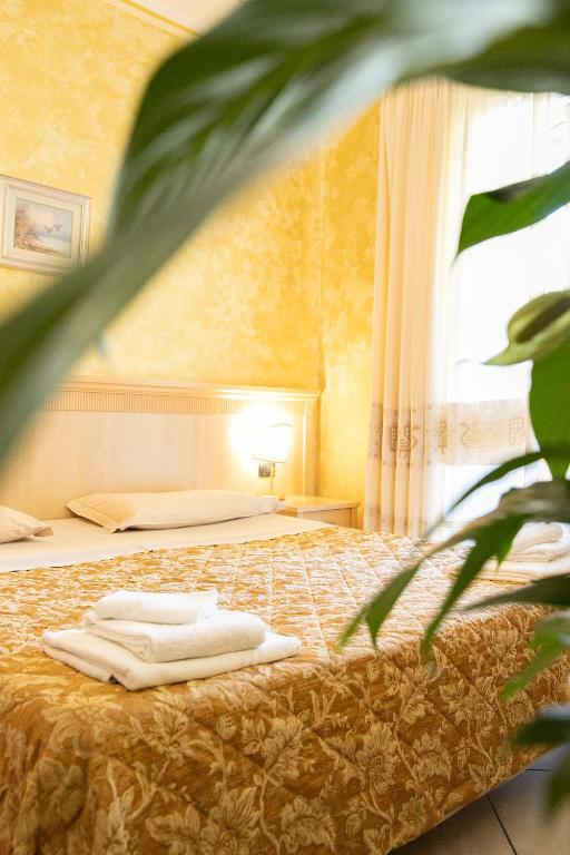 Postel nebo postele na pokoji v ubytování Mannu Hotel