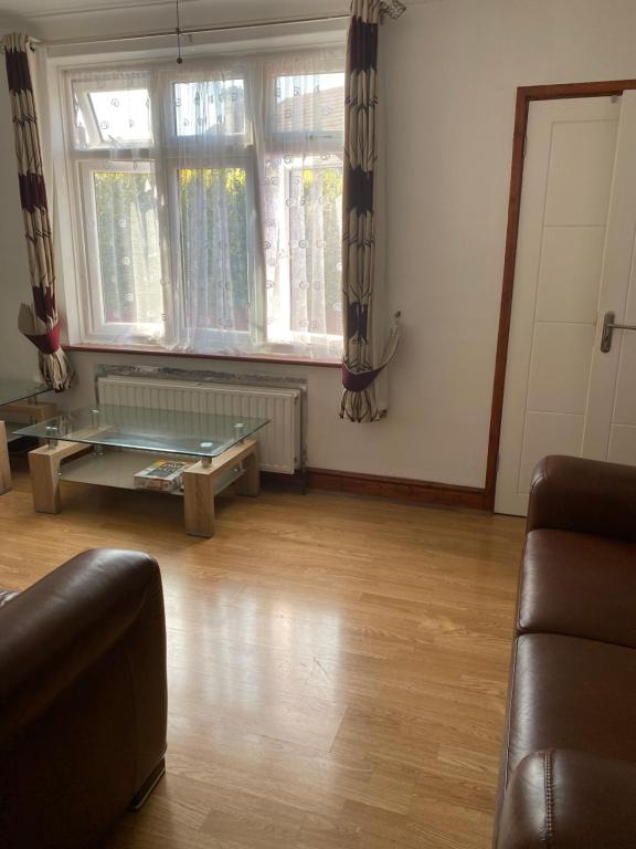 a living room with a couch and a table at 35 Holborn road London E13 8PH Near EXCEL EXHIBITION CENTRE in London
