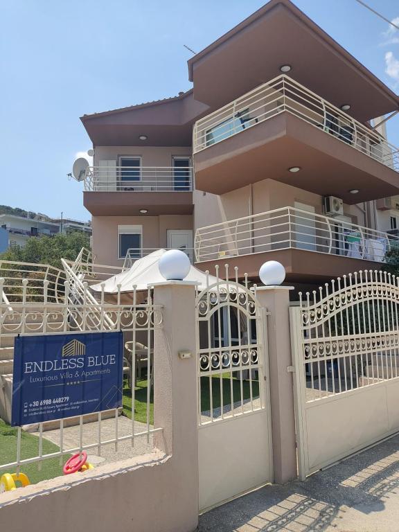a house with a gate and a sign in front of it at Endless Blue Garden Villa in Paleo Tsifliki