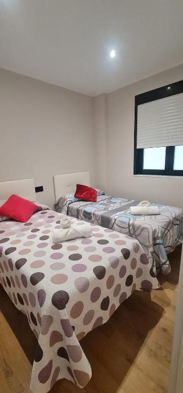 a bedroom with two beds with polka dots at Apartamentos Marta in Ribadeo