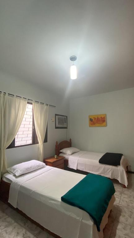Postel nebo postele na pokoji v ubytování Triana Guest House