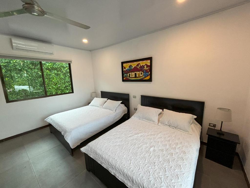 Postel nebo postele na pokoji v ubytování Amazilia Guesthouse