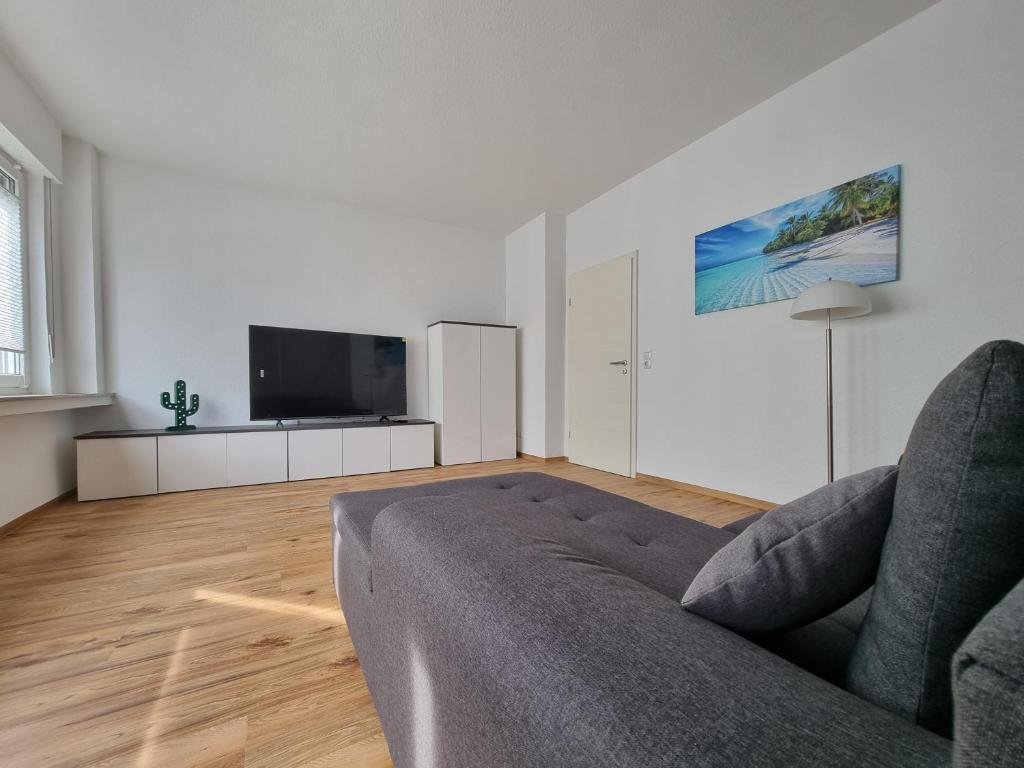 un soggiorno con divano e TV a schermo piatto di Die Insel a Osnabrück