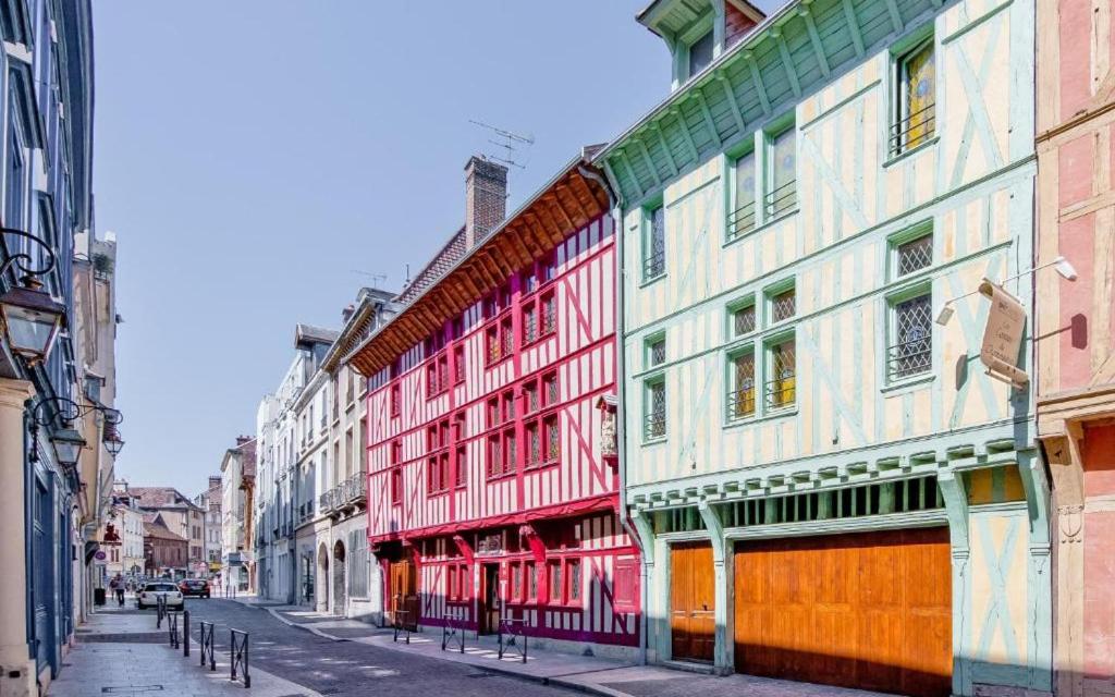 a row of colorful buildings on a city street at Brit Hotel Comtes De Champagne - Troyes Centre Historique in Troyes