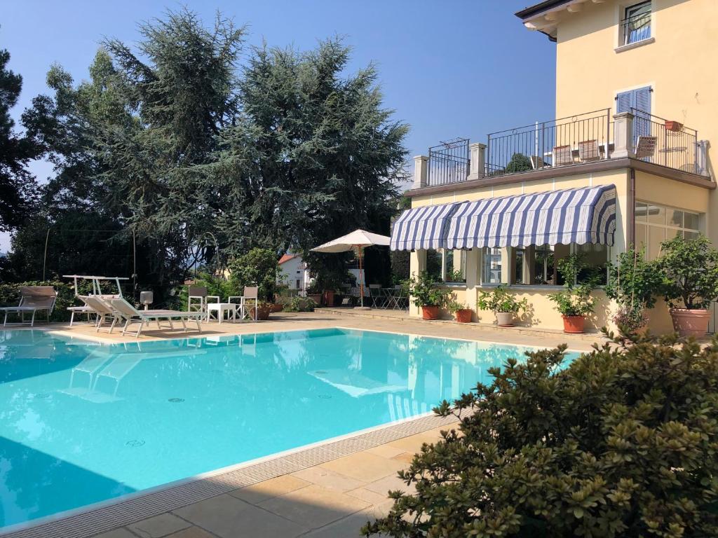 a large swimming pool in front of a building at B&B Villa Eden jacuzzi pool in Domaso