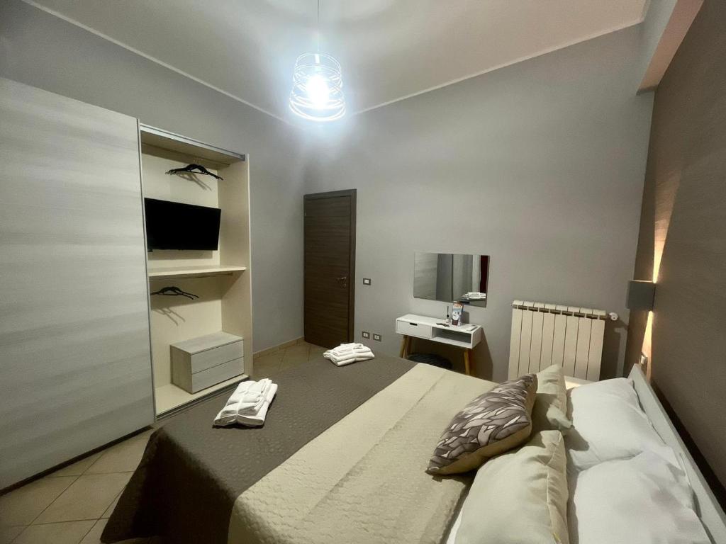 a bedroom with a bed with two towels on it at IL BALCONCINO di GR in Fondi