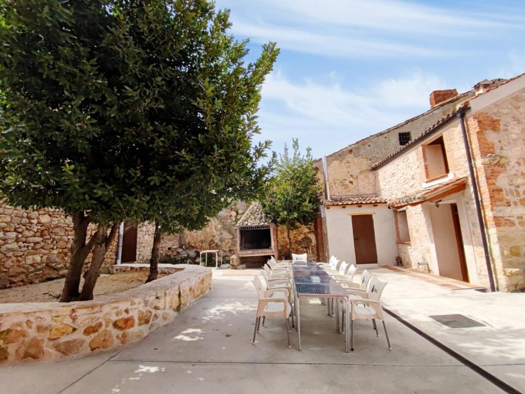 a table and chairs in front of a building at Alojamiento Turístico Casa Los Laureles in Segovia
