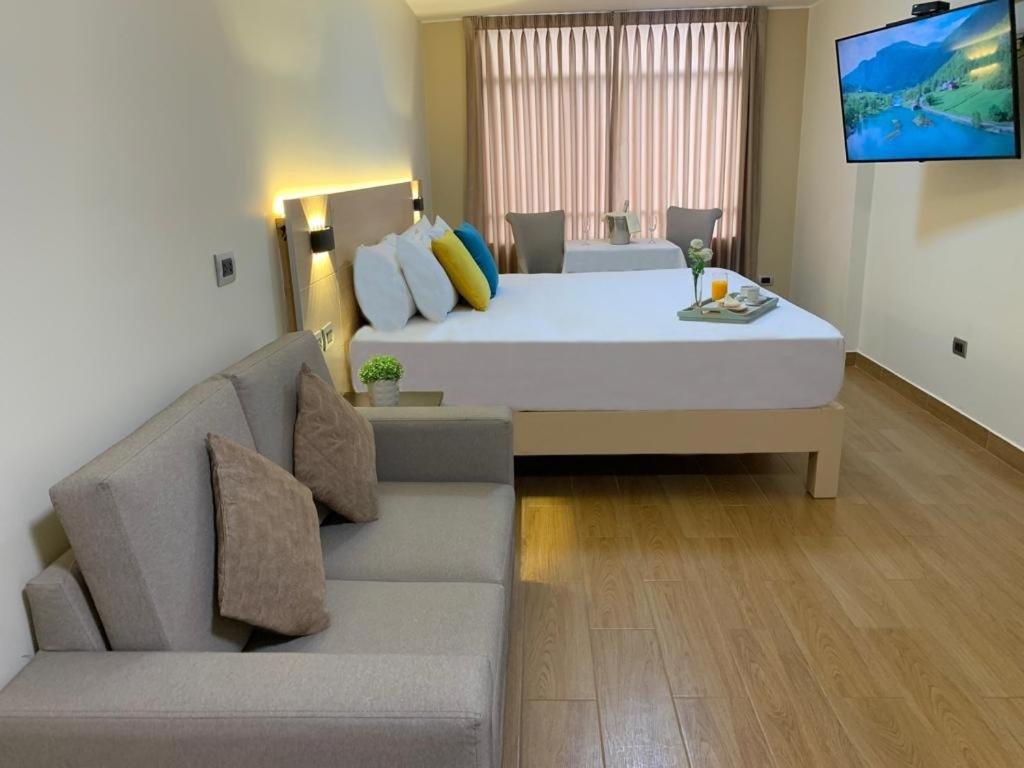 Postel nebo postele na pokoji v ubytování Acuario Hotel & Suite