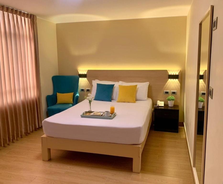 Postel nebo postele na pokoji v ubytování Acuario Hotel & Suite