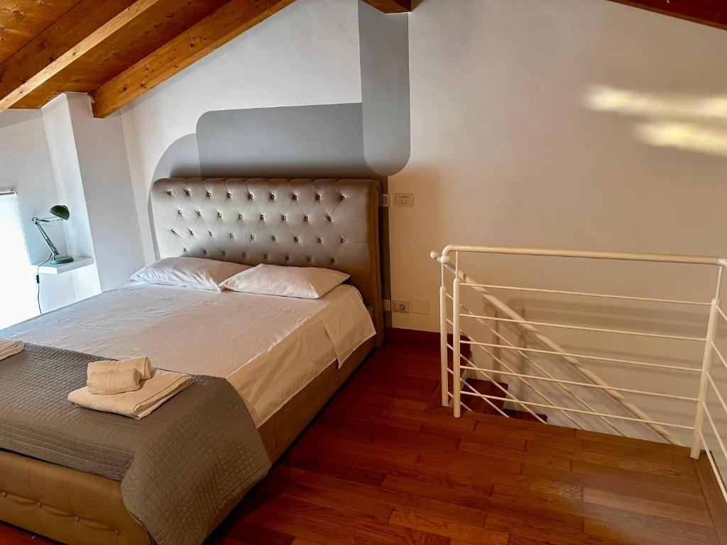 a bedroom with a bed with a metal headboard at Casa di Nia Pietralata in Rome