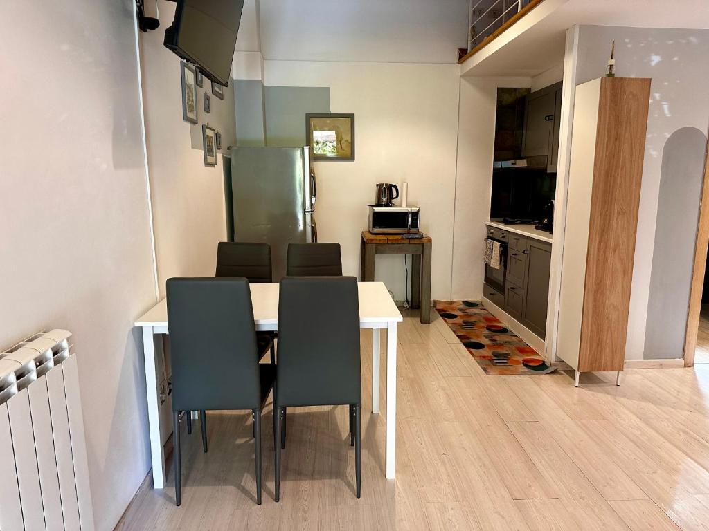a kitchen and dining room with a table and chairs at Casa di Nia Pietralata in Rome