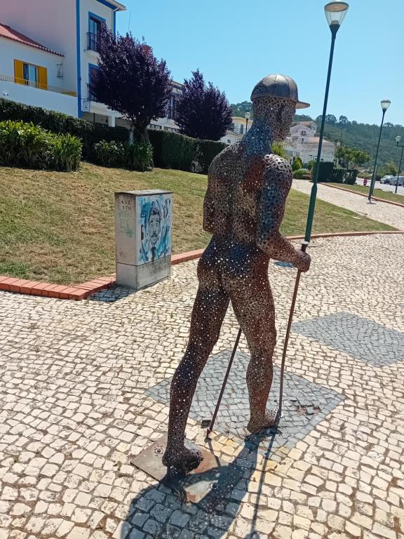 a statue of a person holding a baseball bat at Sol Mar in Odeceixe
