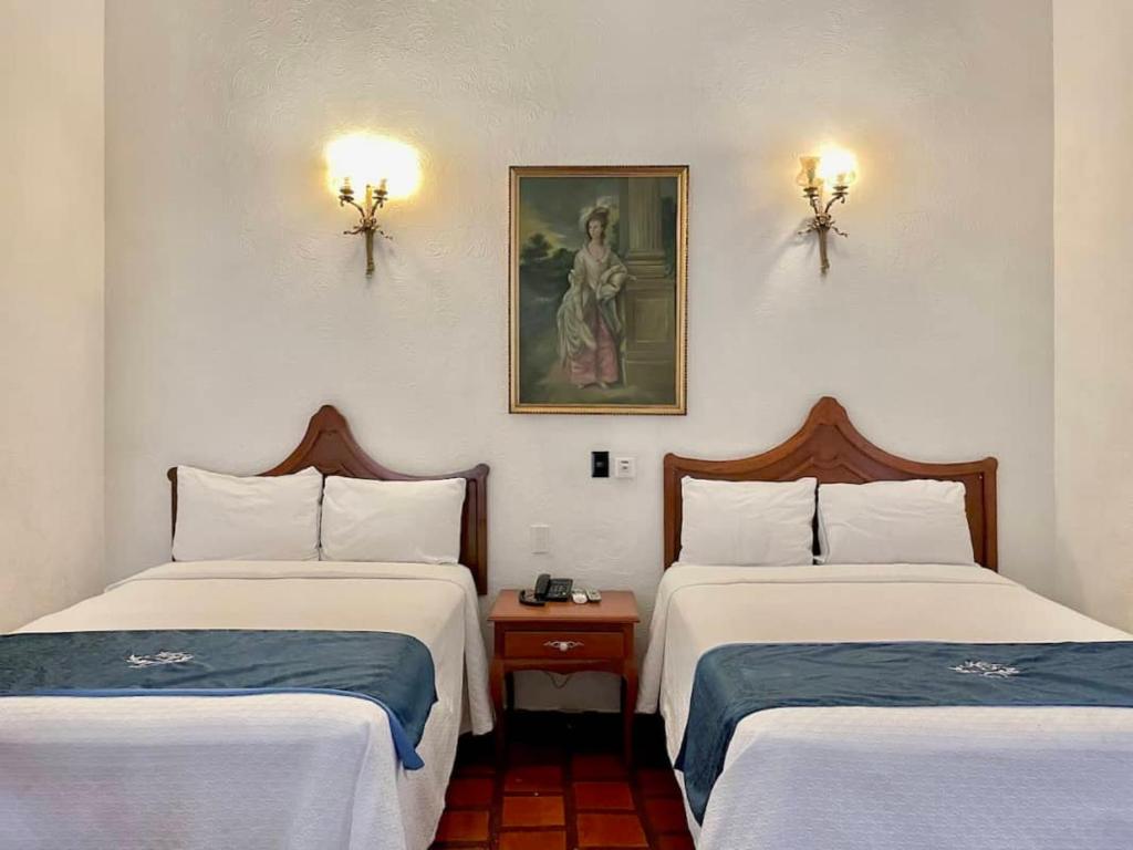 Postel nebo postele na pokoji v ubytování Hotel Frances