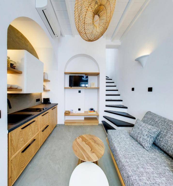 a living room with a couch and a table at Skepi Town Houses in Mikonos