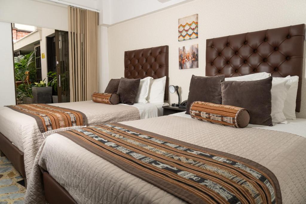 Postel nebo postele na pokoji v ubytování Hotel Alamos Del Parque