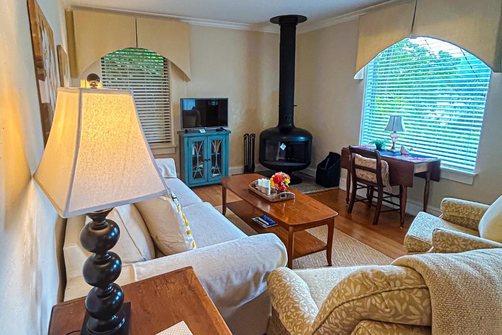 a living room with a couch and a wood stove at Stone Cottage 1973 in Lake Junaluska