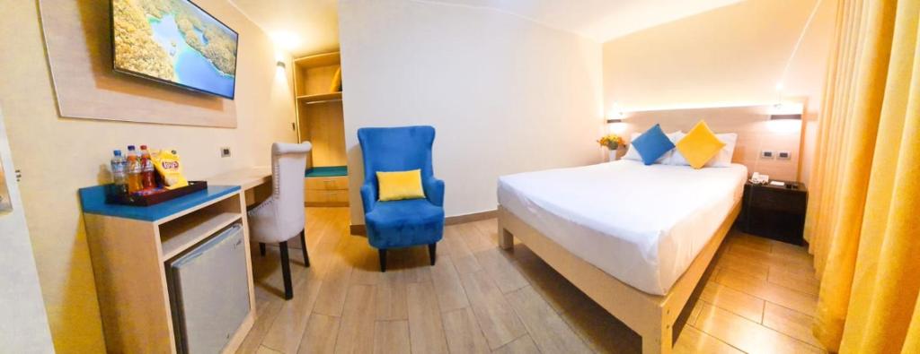 Postel nebo postele na pokoji v ubytování Acuario Hotel & Suite