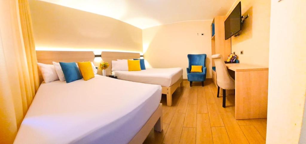 Postel nebo postele na pokoji v ubytování Acuario Hotel & Suite