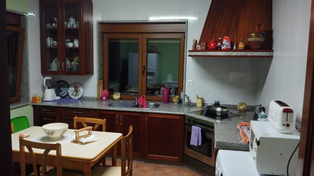 a kitchen with a table and a counter top at Casa Herbellas in Cedeira