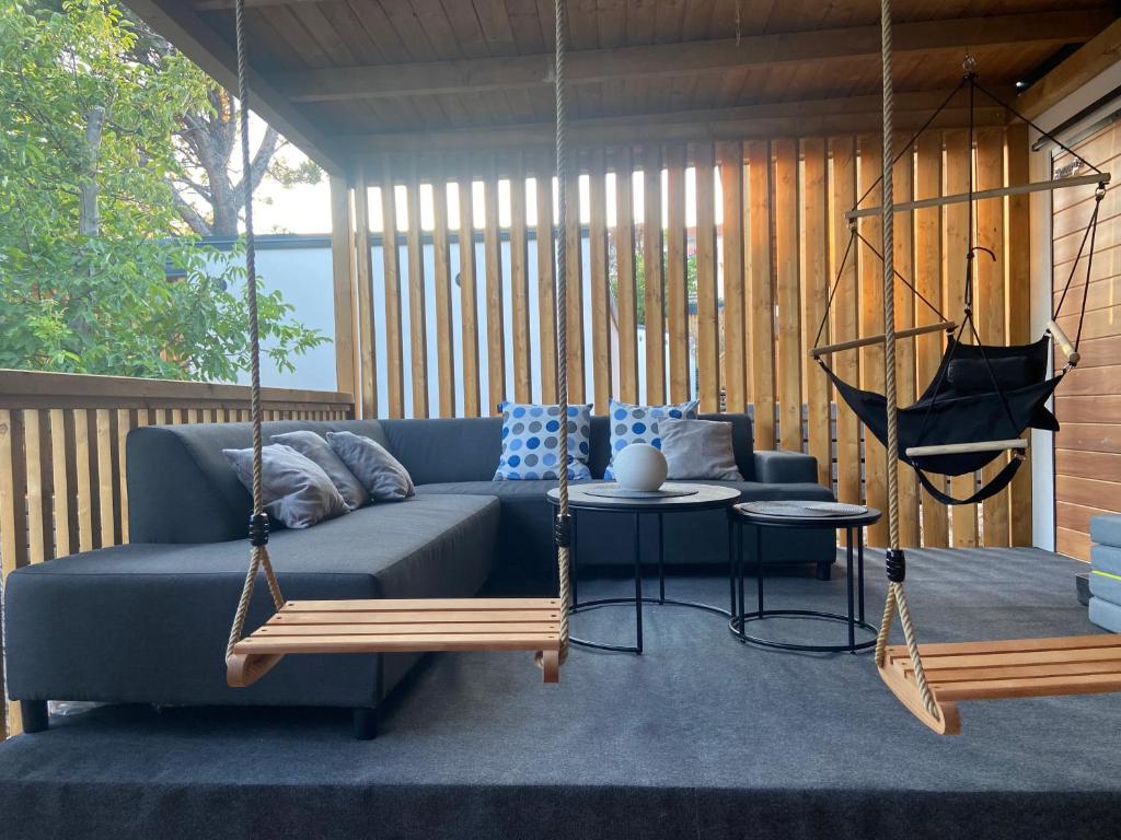 a porch with a blue couch and a swing at Charming Camino House in Selce