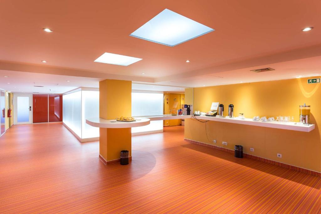 A hotel refreshment area with counters, coffee machines, and buffet service.