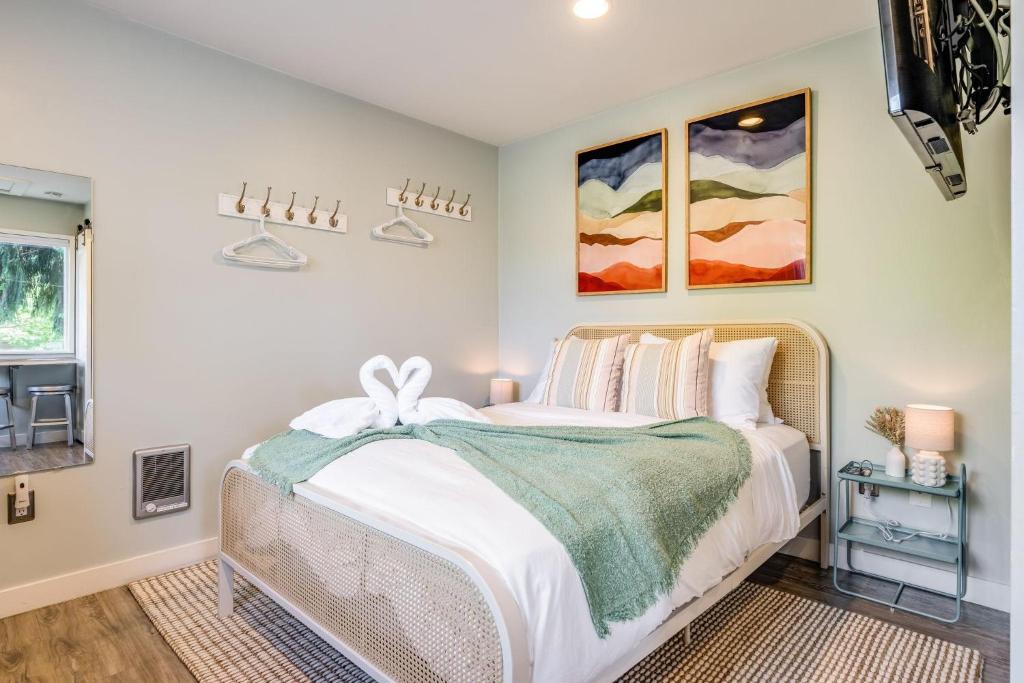 a bedroom with a large bed with white sheets at Perch - Ballard Cozy in Seattle