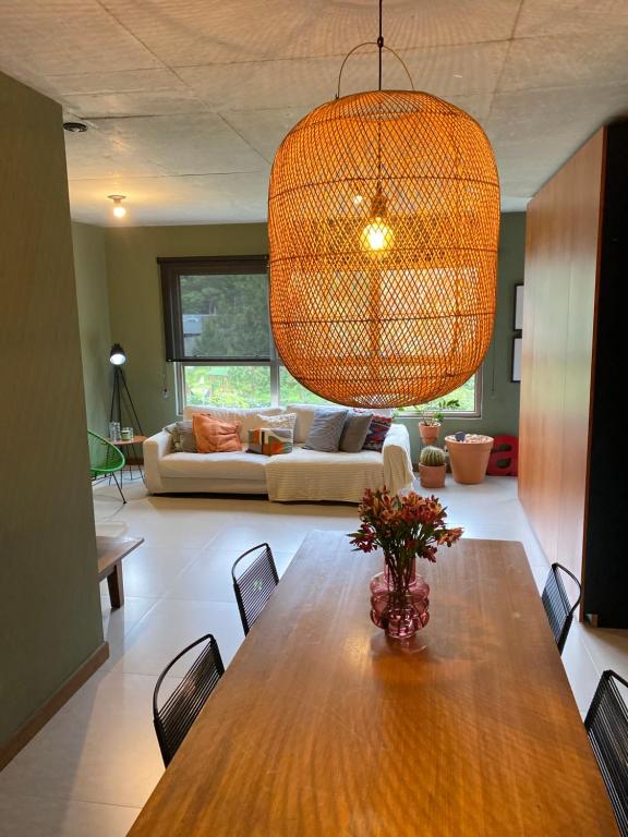 a dining room with a table and a couch at Apartamento praia brava in Itajaí