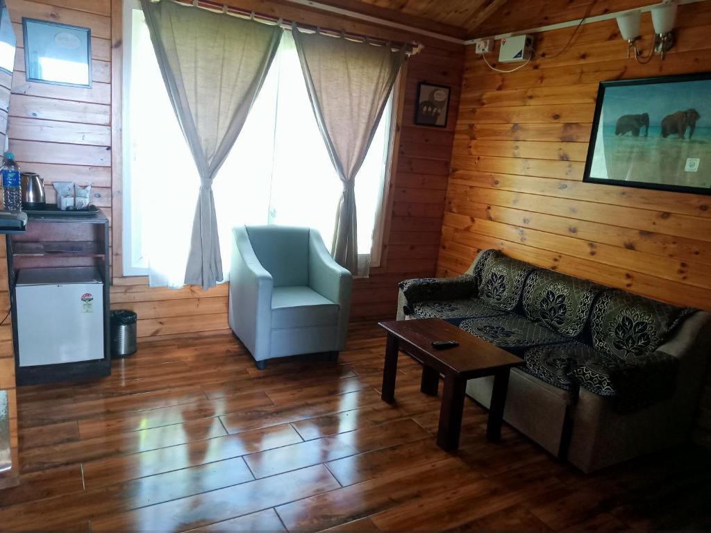 a living room with a couch and a chair at Adhvasaha Beach Spa Resort in Port Blair