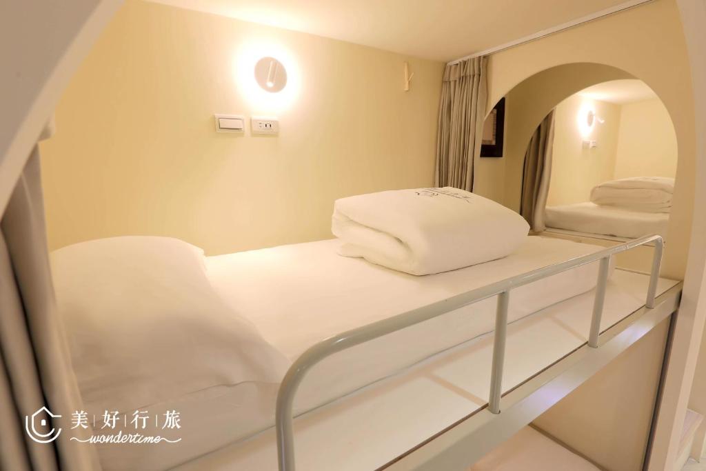 Postel nebo postele na pokoji v ubytování WonderTime3- Hankou' Inn 'Taipei Main Station