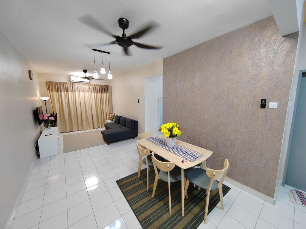 a living room with a table and chairs and a couch at Zanayra Homestay in Melaka