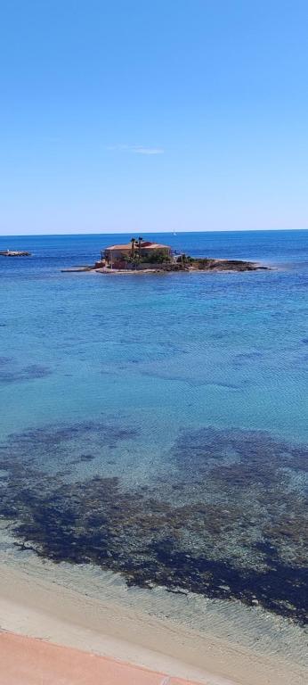 an island in the middle of the ocean at Appartamento d' amare in Marzamemi