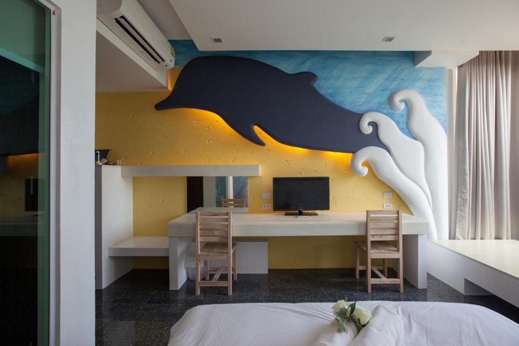 Postel nebo postele na pokoji v ubytování O-Bay Design Hotel Prachuap