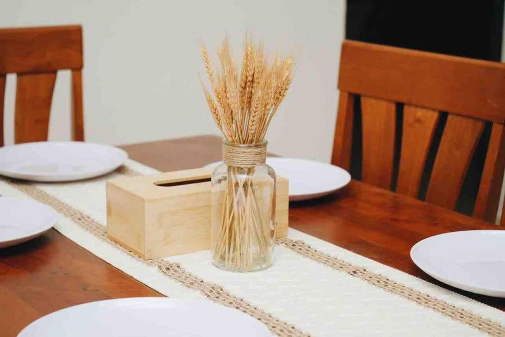 a vase of hay sitting on top of a table at Trio homestay Bandar Kuala Terengganu in Kuala Terengganu