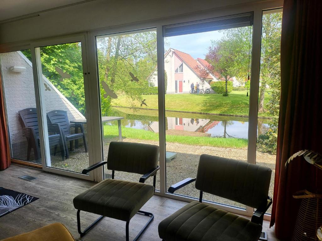 a room with two chairs and a large window at Sleepspot Wedde in Wedde