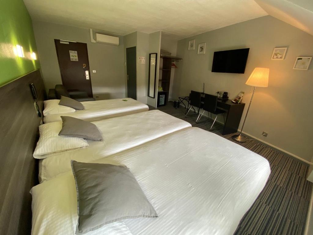 Postel nebo postele na pokoji v ubytování Hôtel Bagatelle