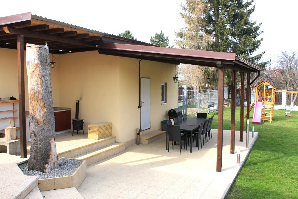 a patio with a table and chairs under a pavilion at Wellness Villa Totina in Liptovský Mikuláš – Demänová