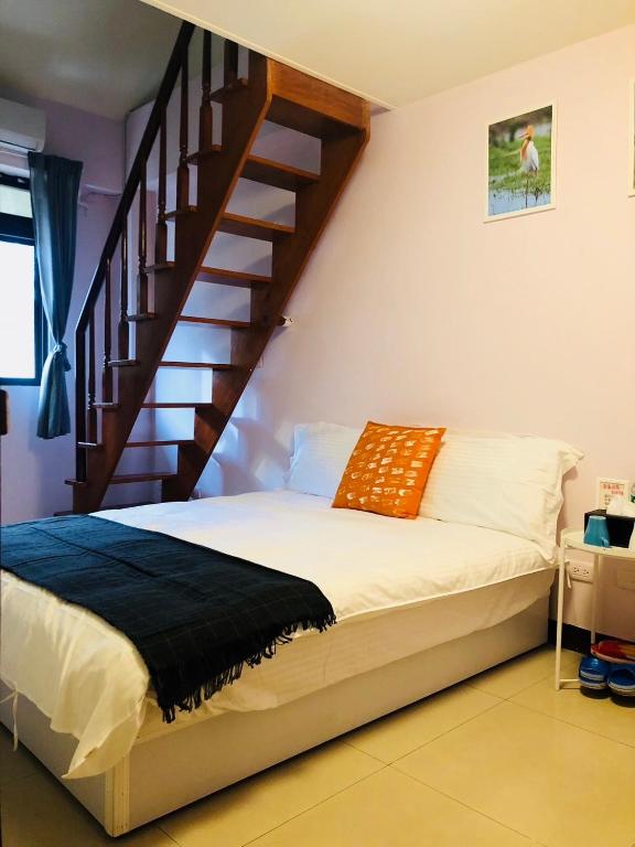 Postel nebo postele na pokoji v ubytování Yi Jia Homestay