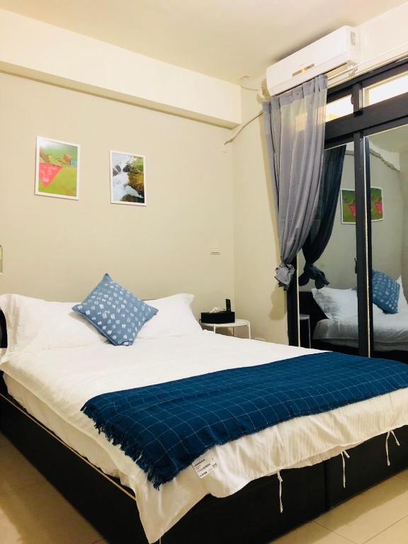 Postel nebo postele na pokoji v ubytování Yi Jia Homestay