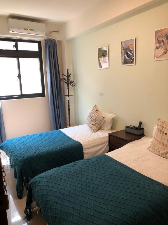 Postel nebo postele na pokoji v ubytování Yi Jia Homestay