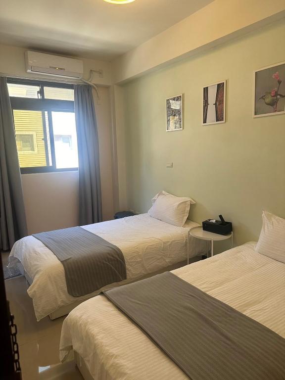 Postel nebo postele na pokoji v ubytování Yi Jia Homestay