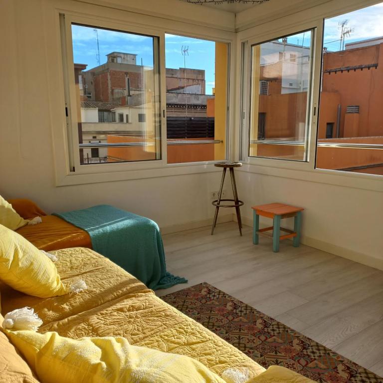 a room with two beds and a window with a view at Apartament Sant Feliu de Guixols in Sant Feliu de Guixols