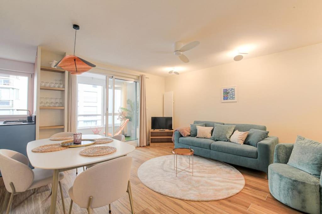 un salon avec un canapé et une table dans l'établissement Appartement raffiné, veranda et parking, Lyon 3, à Lyon