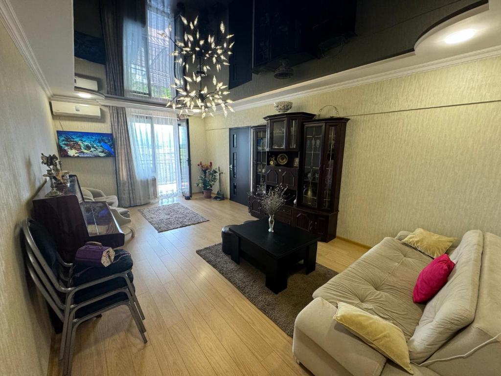 a living room with a couch and a chair at Elles apartment in K'obulet'i
