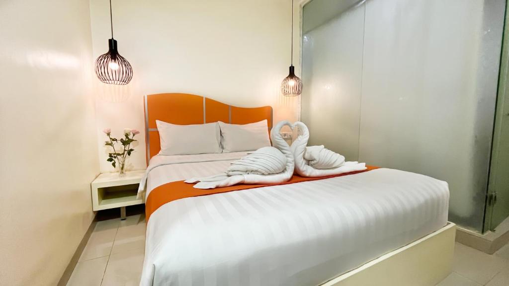 Postel nebo postele na pokoji v ubytování Sahid Vanilla Nagoya Batam