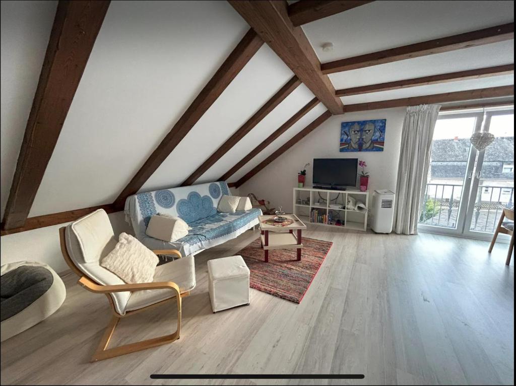 a living room with a blue couch and a tv at Must love dogs in Koblenz