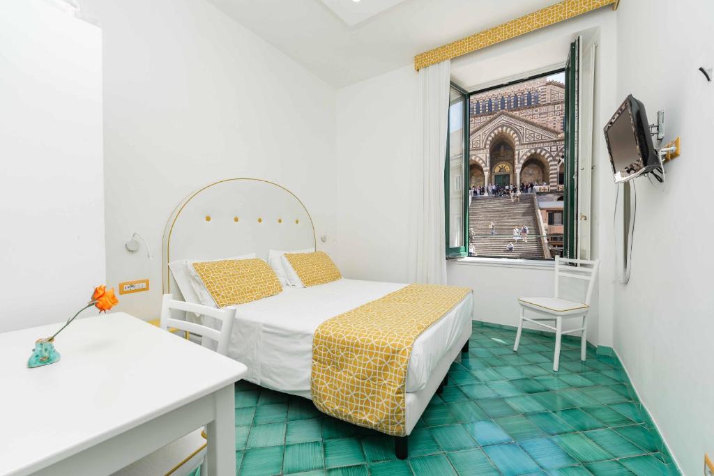 Postel nebo postele na pokoji v ubytování Albergo S. Andrea