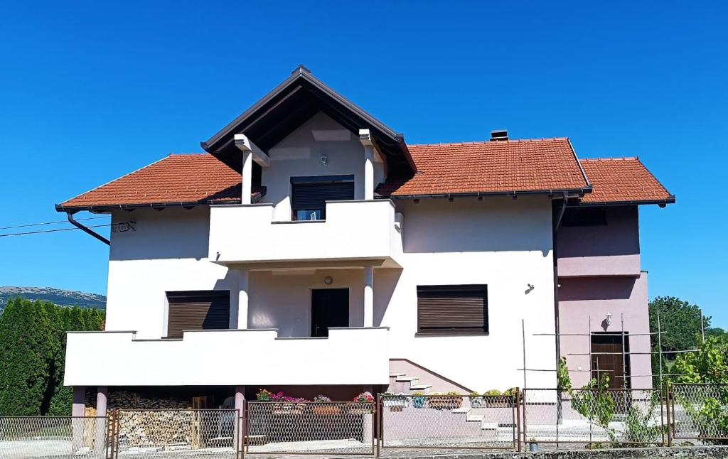 a white house with a red roof at Apartman Zdenka 2 in Livno