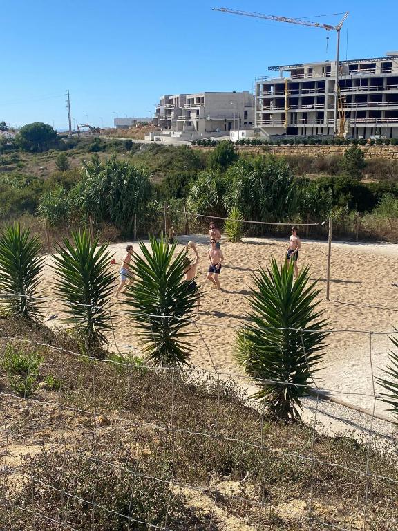 a group of people playing soccer on a beach at WOT Ericeira Surf Hostel in Ericeira