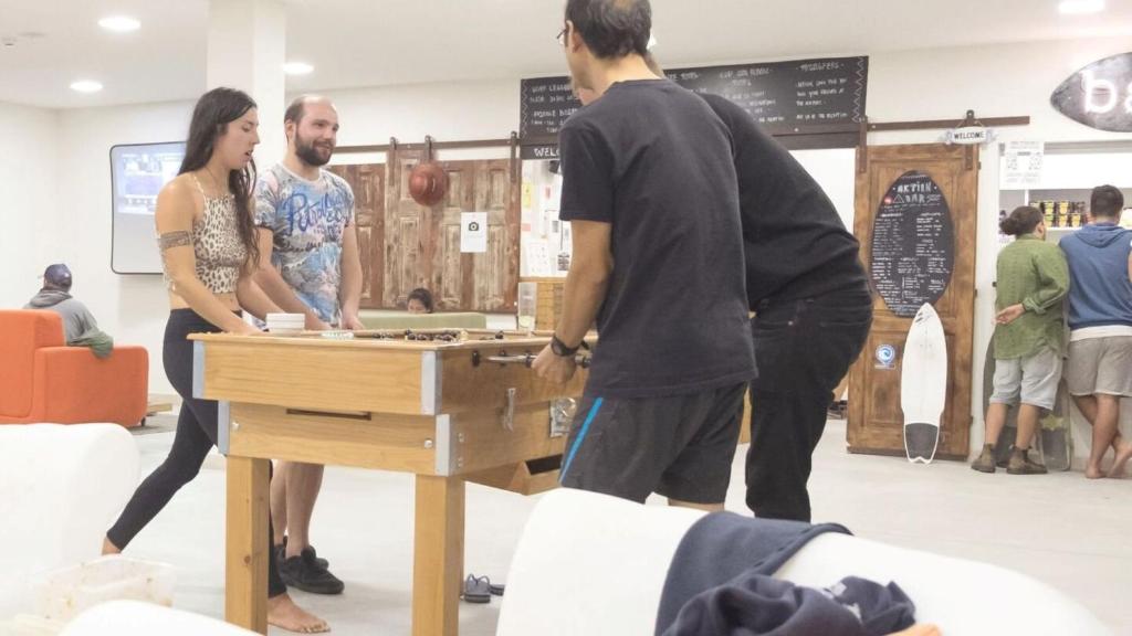 a group of people standing around a table at WOT Ericeira Surf Hostel in Ericeira